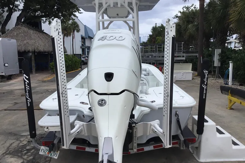 Slide: The Image of 2020 Yellowfin 24 Bay CE boat with powerful outboard motor, parked on a trailer. - 8