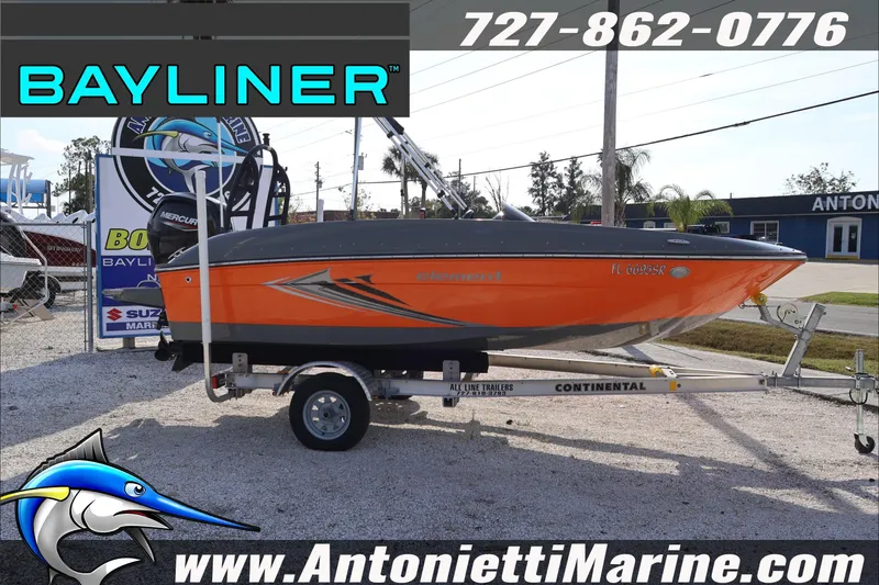 Slide: The Image of 2020 Bayliner Element E16 boat interior with orange seating, steering wheel, and dashboard. - 12