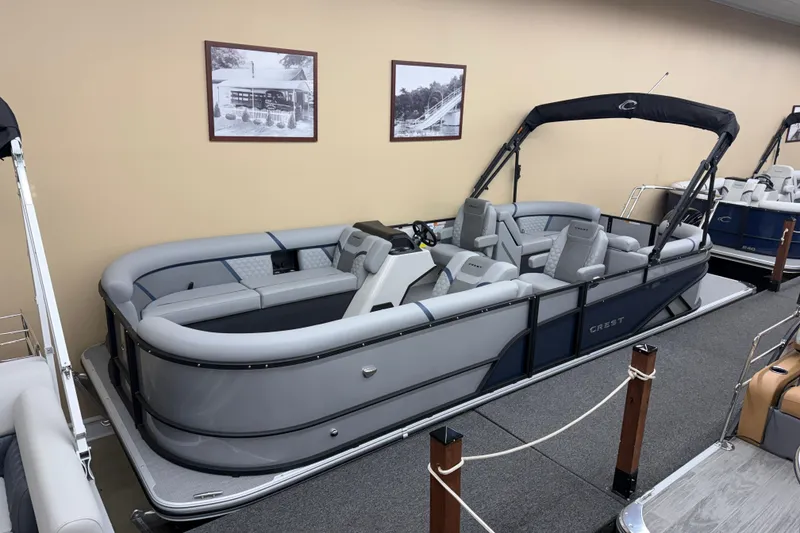 The Image of 2026 Crest Conquest 230 SLC pontoon boat in showroom, featuring sleek design and comfortable seating. - 0