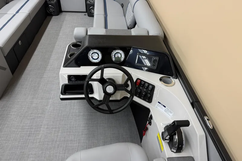Slide: The Image of 2026 Crest Conquest 230 SLC boat dashboard with steering wheel and control panel. - 8