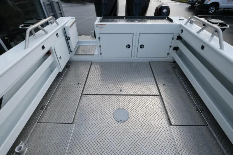 Slide: The Image of 2023 Hewescraft 270 Alaskan ET HT boat deck with storage compartments and metal flooring. - 10