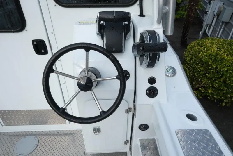 Slide: The Image of 2023 Hewescraft 270 Alaskan ET HT boat steering wheel and controls. - 11