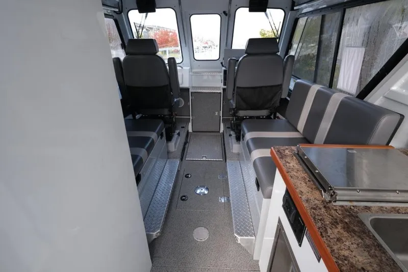 Slide: The Image of Interior of 2023 Hewescraft 270 Alaskan ET HT boat with seating and kitchenette. - 14