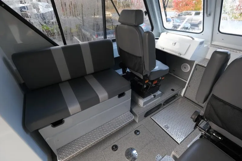 Slide: The Image of Interior of 2023 Hewescraft 270 Alaskan ET HT boat with seating and control area. - 15