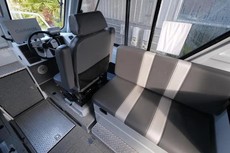 Slide: The Image of 2023 Hewescraft 270 Alaskan ET HT interior with steering wheel and seating. - 16