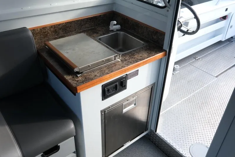 Slide: The Image of 2023 Hewescraft 270 Alaskan ET HT boat interior with sink and counter. - 17