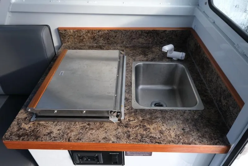 Slide: The Image of Compact kitchen area in 2023 Hewescraft 270 Alaskan ET HT boat. - 18