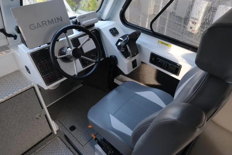 Slide: The Image of 2023 Hewescraft 270 Alaskan ET HT boat interior with Garmin navigation system. - 19