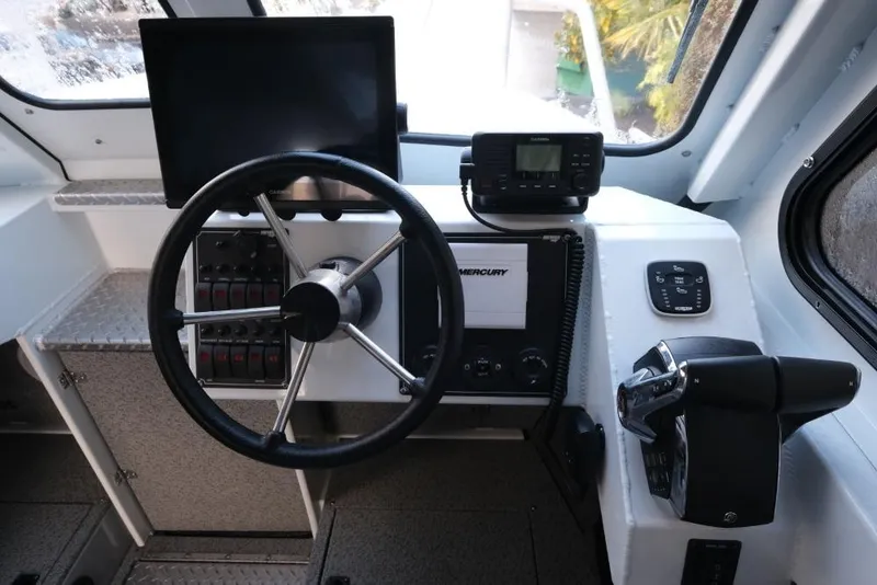 Slide: The Image of 2023 Hewescraft 270 Alaskan ET HT boat cockpit with steering wheel and control panel. - 20