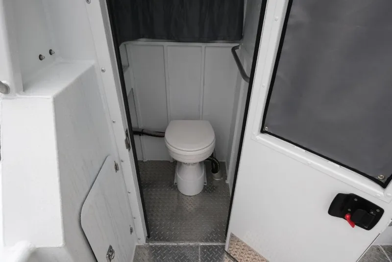 Slide: The Image of Interior of 2023 Hewescraft 270 ALASKAN ET HT boat bathroom with toilet. - 24