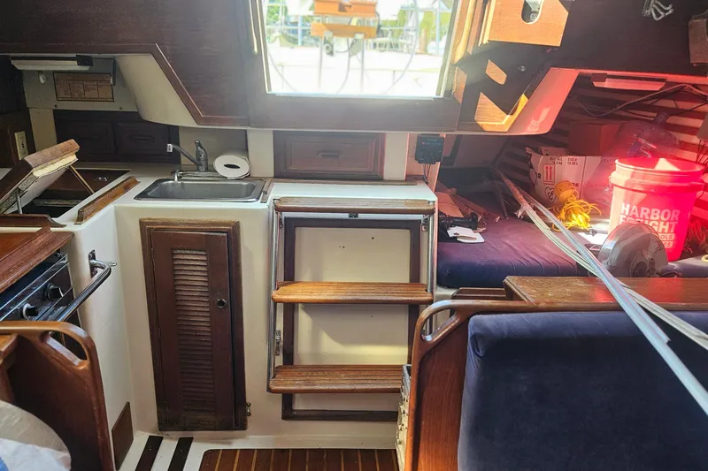 Slide: The Image of Interior of 1984 Endeavour 33 sailboat with kitchenette and seating area. - 13