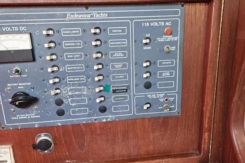 Slide: The Image of Control panel of a 1984 Endeavour 33 yacht with switches and voltage indicators. - 14