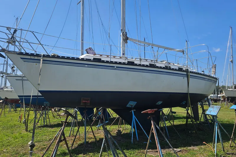 Slide: The Image of 1984 Endeavour 33 sailboat on stands in a boatyard under clear blue sky. - 3