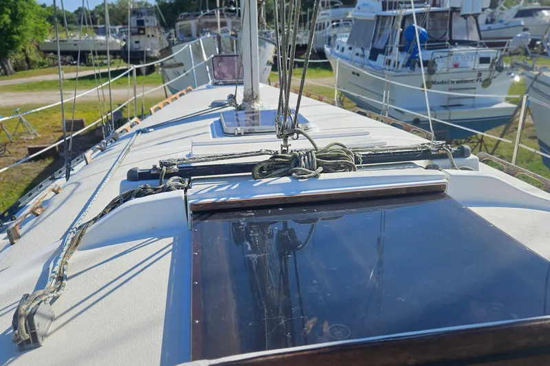 Slide: The Image of 1984 Endeavour 33 sailboat deck with rigging, docked among other boats. - 7