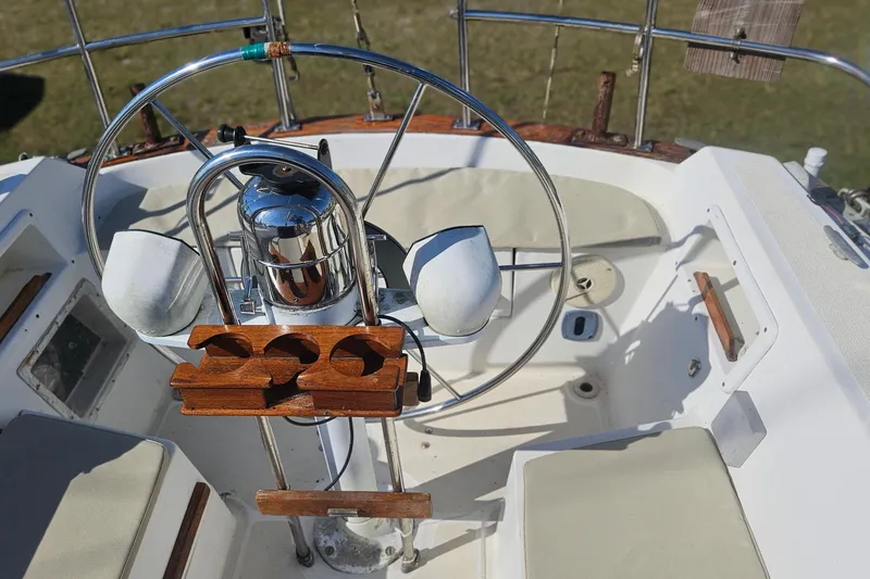 Slide: The Image of Cockpit of 1984 Endeavour 33 sailboat with steering wheel and wooden cup holders. - 8