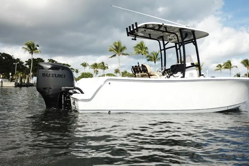 Slide: The Image of 2019 Sportsman Heritage 231 Center Console boat with Suzuki engine on water. - 12