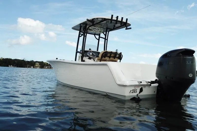 Slide: The Image of 2019 Sportsman Heritage 231 Center Console boat on calm water under blue sky. - 14