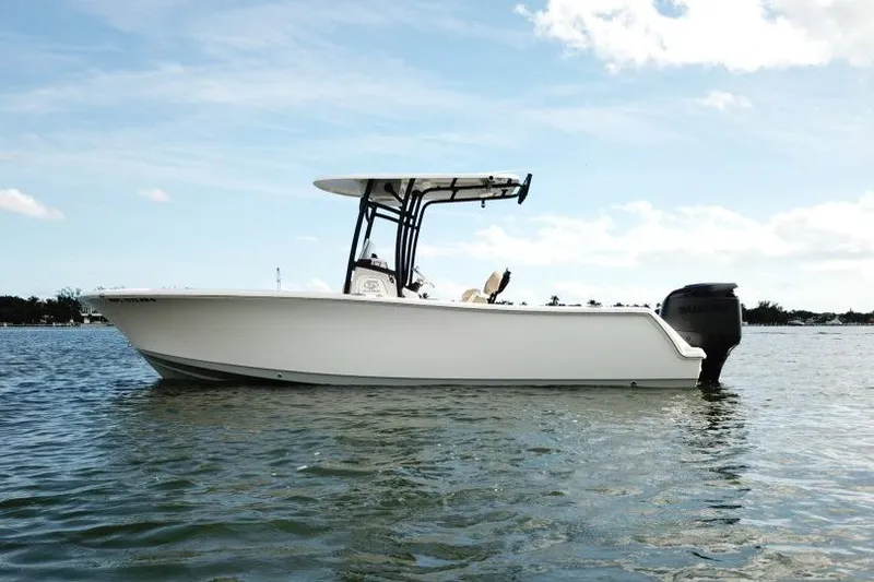 Slide: The Image of 2019 Sportsman Heritage 231 Center Console boat on calm water under blue sky. - 3