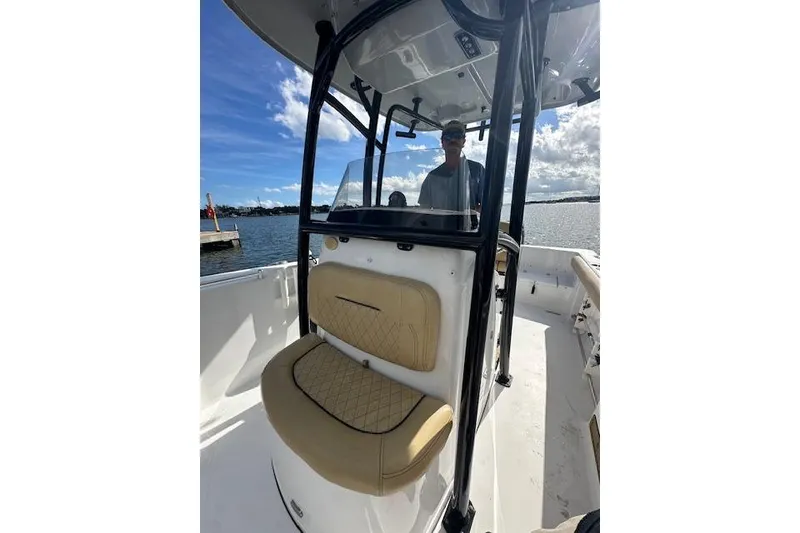 Slide: The Image of 2019 Sportsman Heritage 231 Center Console boat on water, featuring tan seating and black frame. - 6