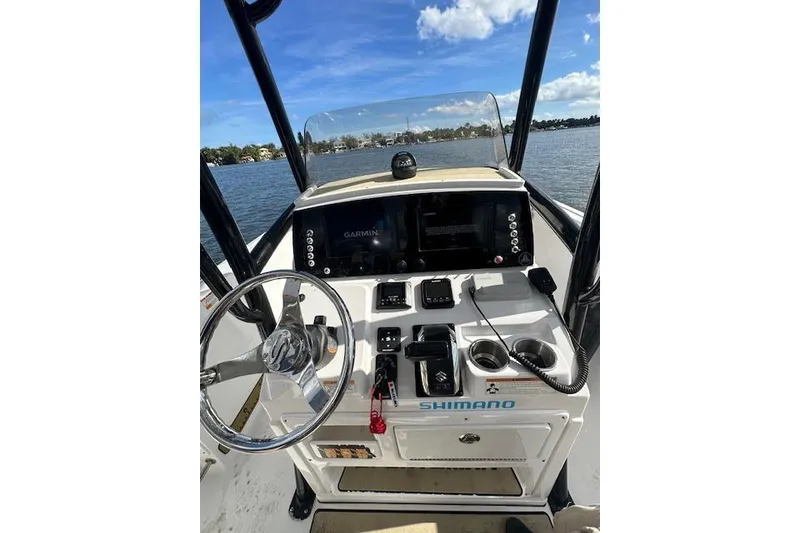 Slide: The Image of 2019 Sportsman Heritage 231 Center Console boat dashboard with steering wheel and navigation equipment. - 7