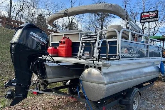 Slide: The Image of 2023 Sun Tracker Bass Buggy 16 XL Select pontoon boat with Mercury engine on trailer. - 10