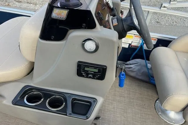 Slide: The Image of 2023 Sun Tracker Bass Buggy 16 XL Select boat console with steering wheel and cup holders. - 12