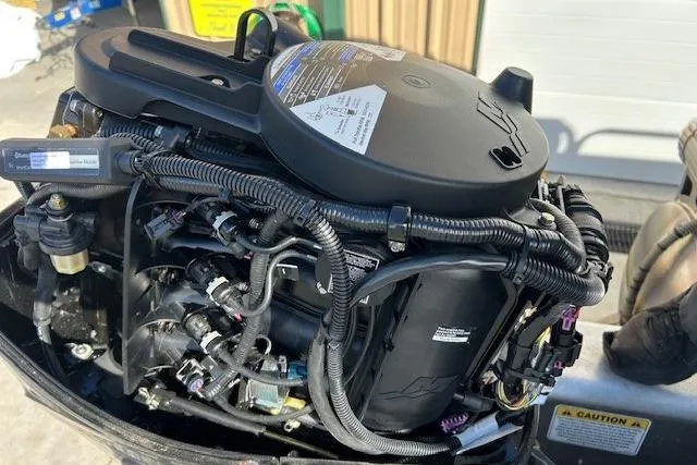 Slide: The Image of 2023 Sun Tracker Bass Buggy 16 XL Select engine close-up, showcasing intricate wiring and components. - 7