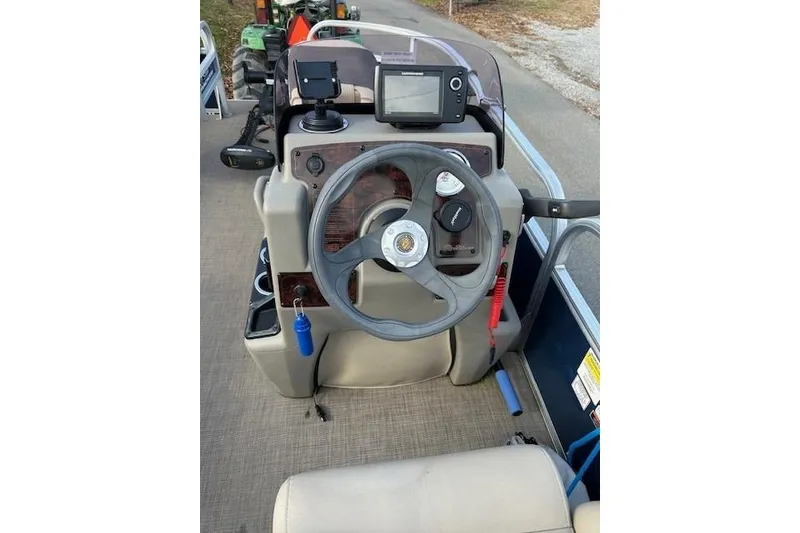 Slide: The Image of 2023 Sun Tracker Bass Buggy 16 XL Select boat dashboard with steering wheel and controls. - 9