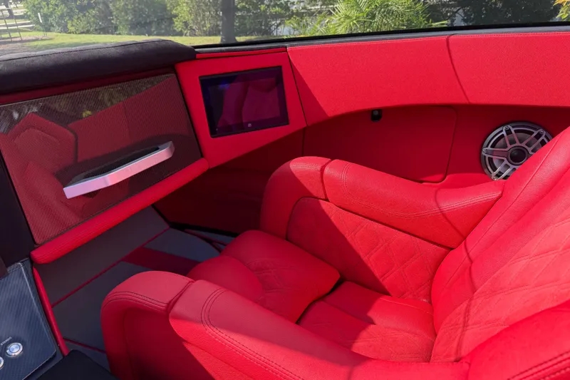 Slide: The Image of Red interior of a 2022 Doug Wright 320 boat with modern seating and speaker system. - 11