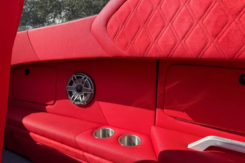 Slide: The Image of Red interior of 2022 Doug Wright 320 boat with speaker and cup holders. - 14