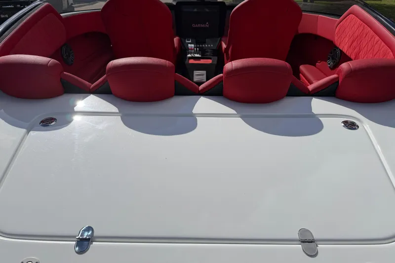 Slide: The Image of 2022 Doug Wright 320 boat interior with red seating and Garmin navigation system. - 16