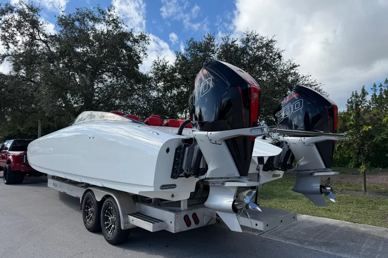 Slide: The Image of 2022 Doug Wright 320 boat with dual outboard engines on a trailer. - 4