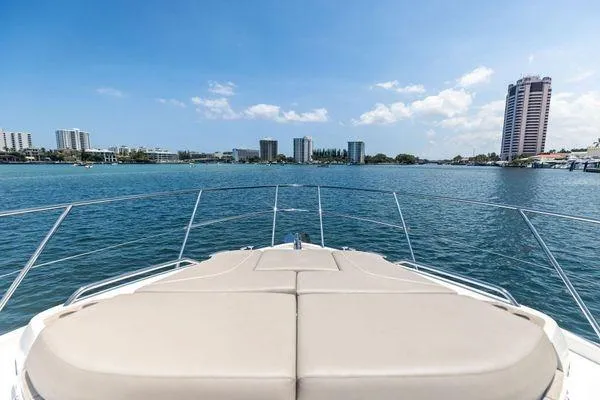 Slide: The Image of Bow view of 2020 Princess V55 yacht cruising near city skyline. - 12