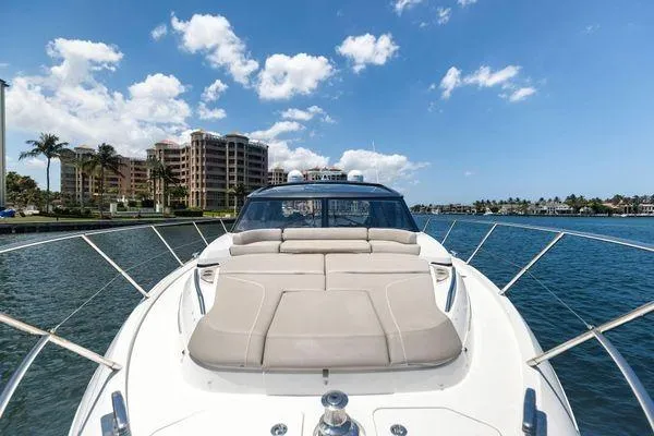 Slide: The Image of 2020 Princess V55 yacht cruising near waterfront buildings under a clear blue sky. - 13
