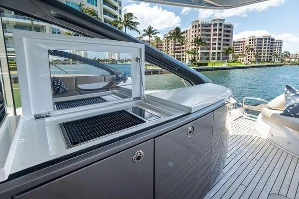 Slide: The Image of Luxury 2020 Princess V55 yacht with sleek outdoor kitchen and waterfront view. - 16