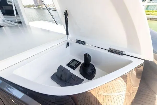 Slide: The Image of 2020 Princess V55 yacht control panel with joystick and display in open compartment. - 18