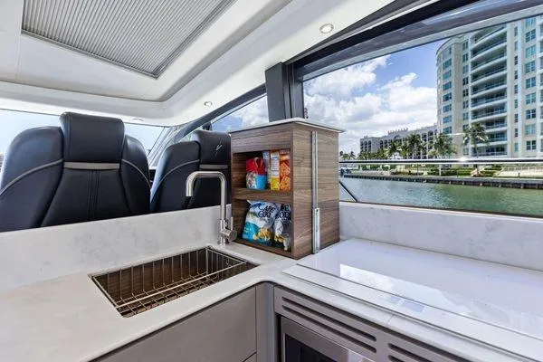 Slide: The Image of Luxurious 2020 Princess V55 yacht interior with modern kitchen and scenic waterfront view. - 26