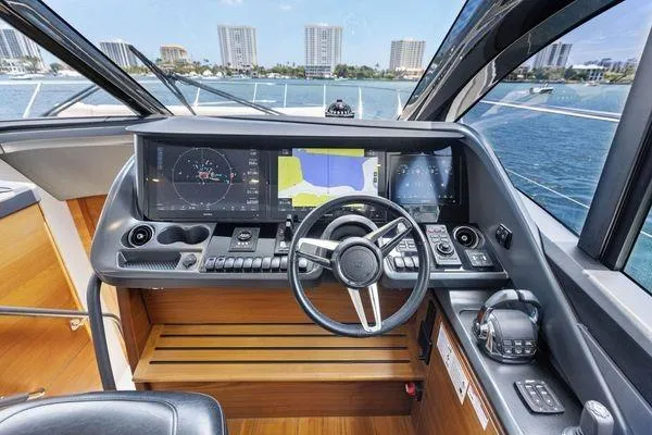 Slide: The Image of Cockpit of 2020 Princess V55 yacht with modern navigation displays and steering wheel. - 27
