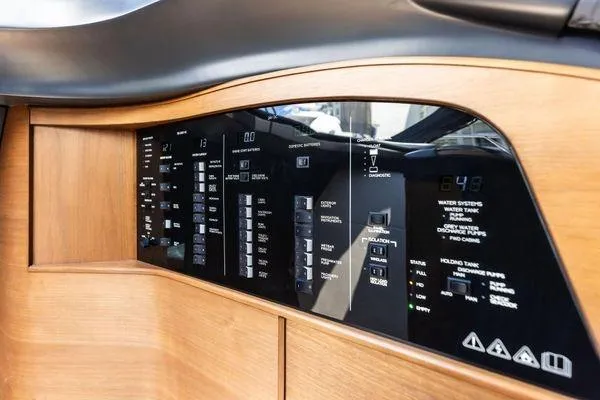 Slide: The Image of Control panel of a 2020 Princess V55 yacht with wooden finish and digital displays. - 33