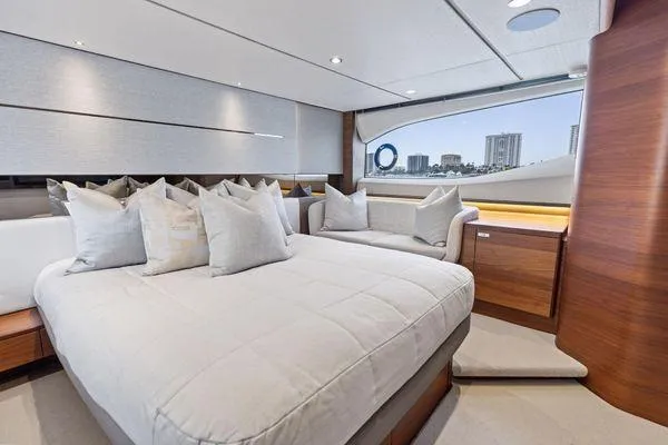 Slide: The Image of Luxurious interior of 2020 Princess V55 yacht with elegant bedding and cityscape view. - 35