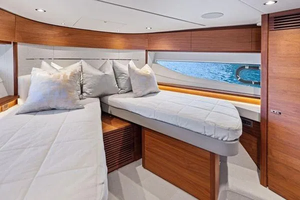Slide: The Image of Luxurious cabin interior of 2020 Princess V55 yacht with twin beds and elegant wood finish. - 38