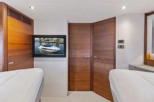 Slide: The Image of Luxurious interior of 2020 Princess V55 yacht with wood paneling and mounted TV. - 39