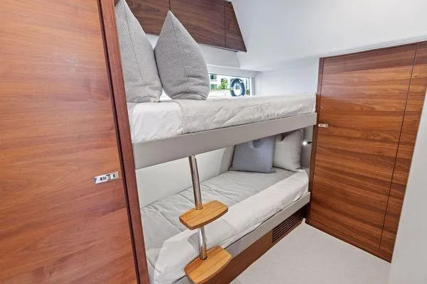 Slide: The Image of Bunk beds in 2020 Princess V55 yacht cabin with wooden interior design. - 40