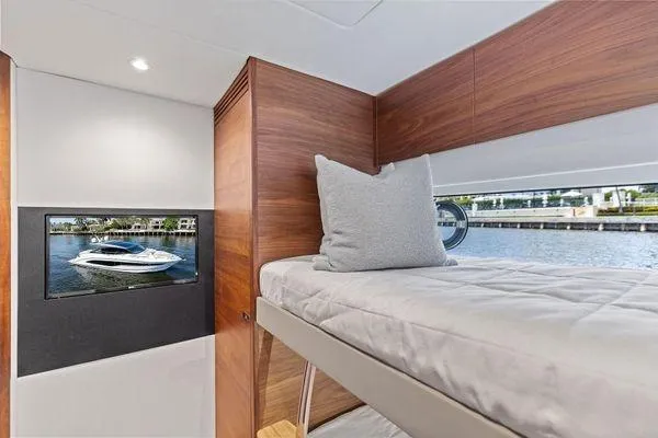 Slide: The Image of Luxurious 2020 Princess V55 yacht interior with cozy bunk bed and scenic window view. - 41