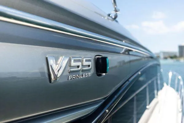 Slide: The Image of 2020 Princess V55 yacht side view with logo, sleek design, and ocean backdrop. - 9