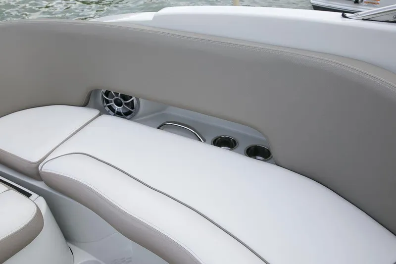 Slide: The Image of 2026 Crownline Eclipse E255 boat interior with cushioned seating and built-in speaker. - 12