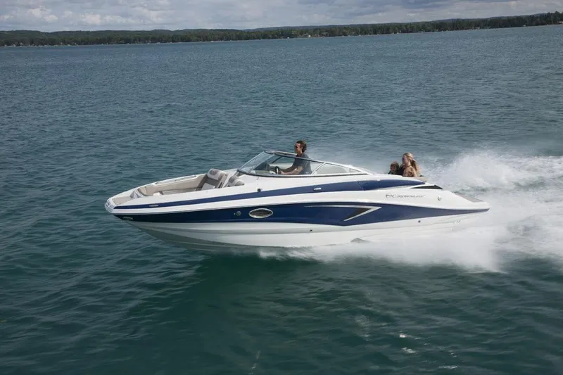 Slide: The Image of 2026 Crownline Eclipse E255 speedboat cruising on a lake with passengers enjoying the ride. - 17