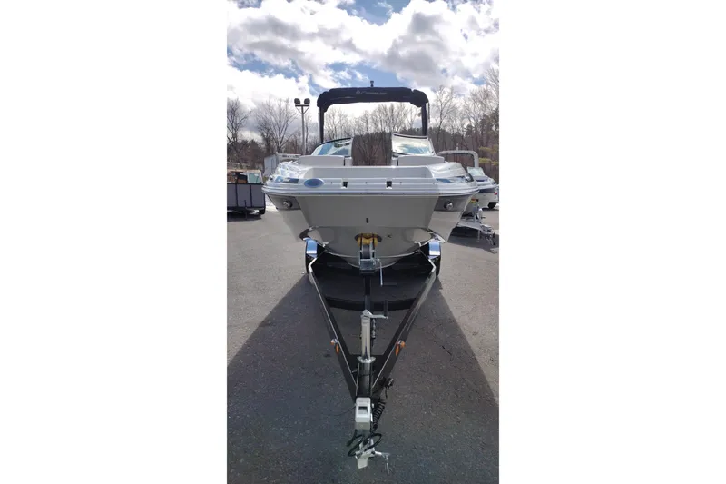 Slide: The Image of 2026 Crownline Eclipse E255 boat on trailer under cloudy sky. - 21