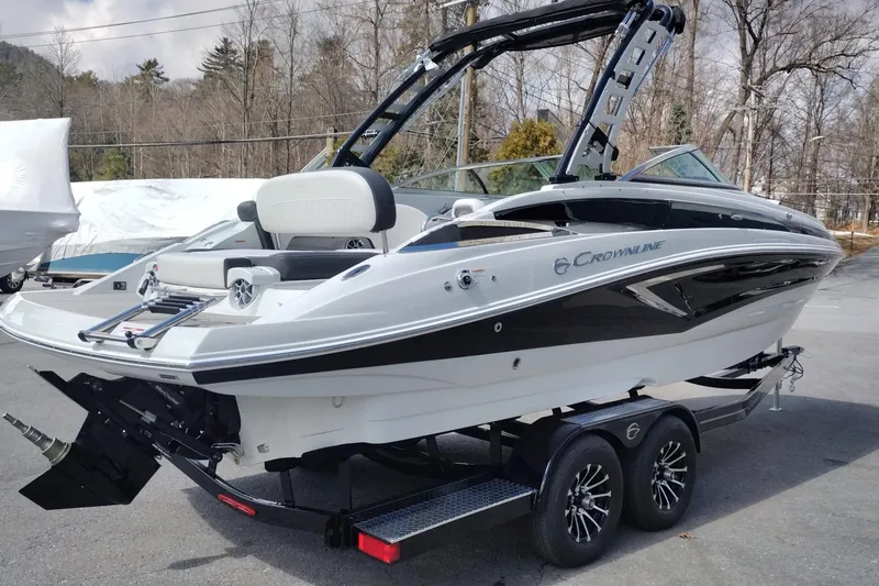 Slide: The Image of 2026 Crownline Eclipse E255 boat on trailer, sleek design, black and white exterior. - 25