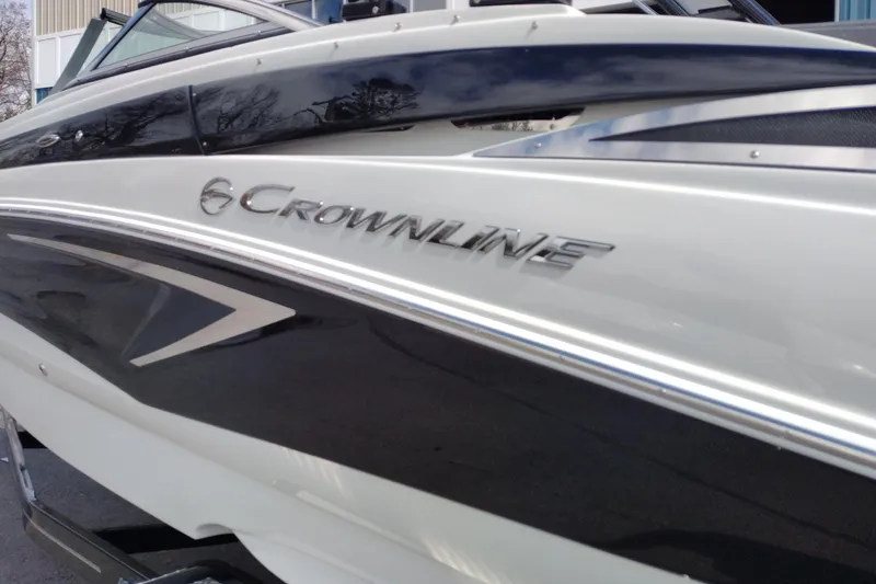 Slide: The Image of 2026 Crownline Eclipse E255 boat, sleek design with logo detail. - 28